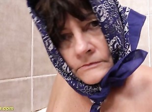 ugly old granny peeing at the bathtub